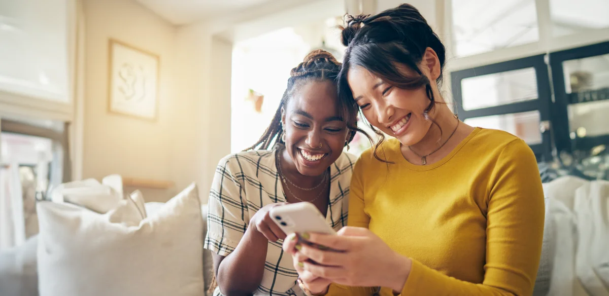 Two student looking at their phone
